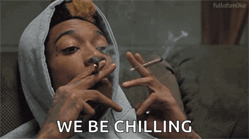 a man in a hooded sweatshirt is smoking a cigarette and saying we be chilling .