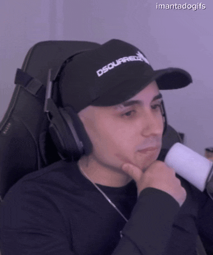 a man wearing headphones and a hat that says dsquared2 on it