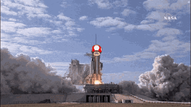 a rocket is being launched by nasa with a red mushroom on top