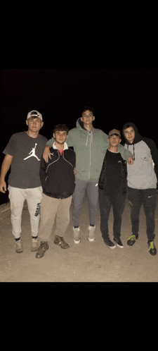 a group of young men are posing for a picture and one of them is wearing an air jordan shirt