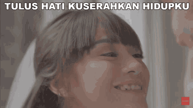 a woman is smiling and the words tulus hati kuserahkan hidupku are above her