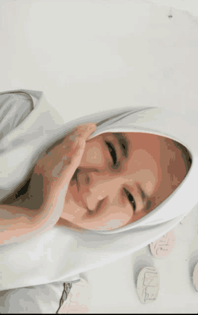 a girl wearing a white hijab is smiling