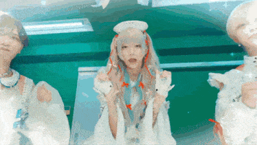 a girl with white hair and red ribbons in her hair is standing next to two other girls