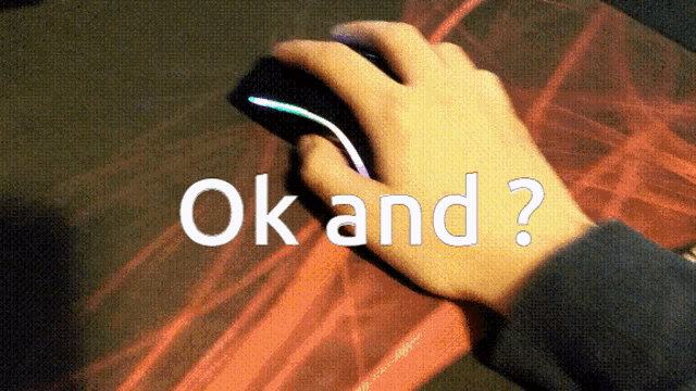 a person 's hand is holding a computer mouse and the words ok and ? are visible