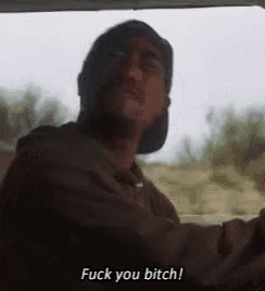 a man wearing a hat is driving a car and says fuck you bitch .