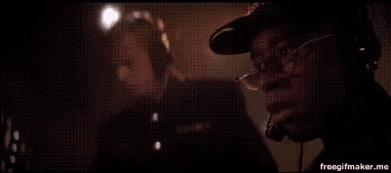 a man is smoking a cigarette in a dark room .