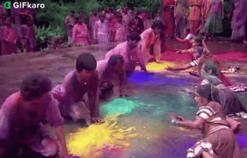 Playing With Colored Powder Gifkaro GIF - Playing With Colored Powder Gifkaro Celebrating Holi GIFs