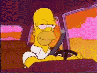homer simpson is wearing a seat belt while driving a car