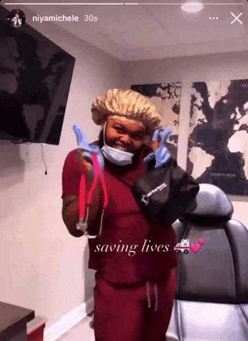a woman in scrubs holds a bag that says saving lives