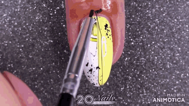 a close up of a person 's nails being painted with a brush