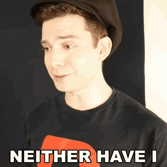a man wearing a hat and a shirt that says neither have i on it