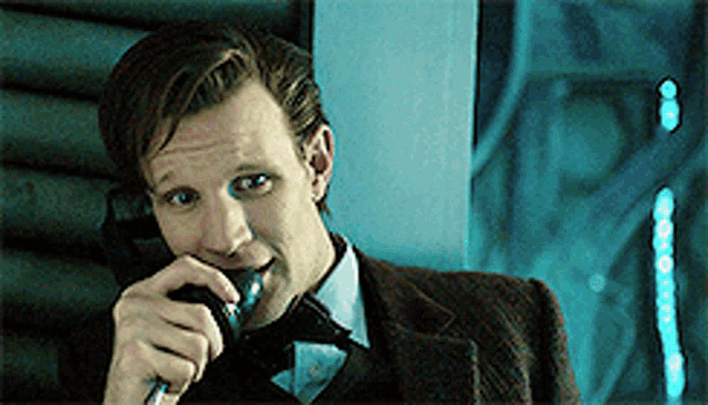 a man in a suit and tie talking on a phone