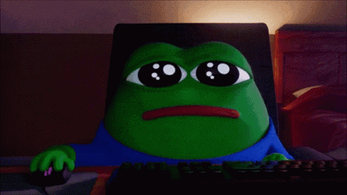 a green frog with big eyes is sitting at a computer keyboard