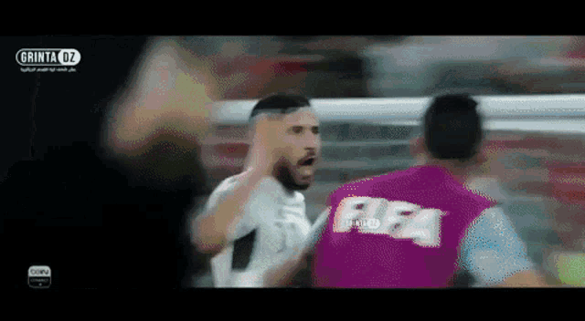 a man wearing a purple vest with fifa on it