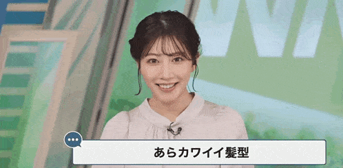 a woman in a white shirt is smiling in front of a sign that says ' ntv ' on it