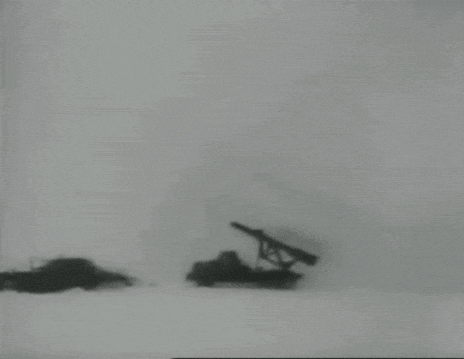 a black and white photo of a missile being launched from a truck in the snow .