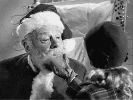 a black and white photo of a child touching a man 's face .