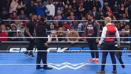 a wrestler wearing a shirt that says ' vaim ' on it