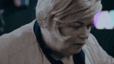 a close up of a woman 's face with short blonde hair