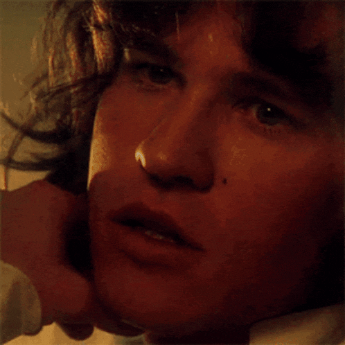 a close up of a man 's face with the words val kilmer as jim morrison above him