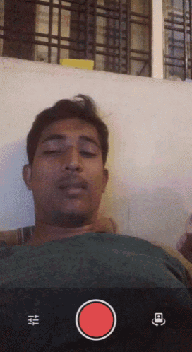 a man with his eyes closed is being recorded with a red circle