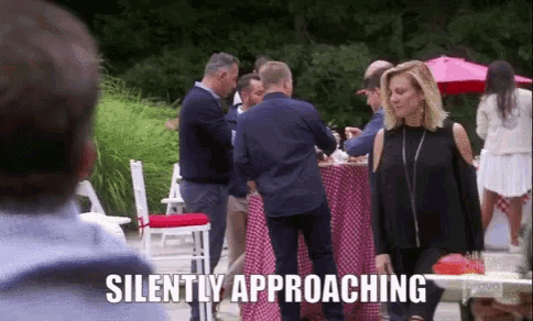 a group of people standing around a table with the words silently approaching on the bottom