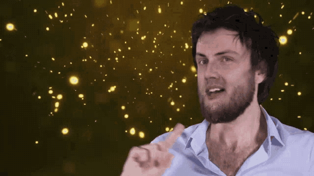 a man with a beard is giving a thumbs up in front of a golden background