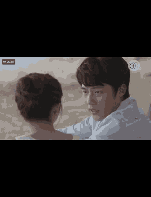 a man and a woman are looking at each other and the number 3 is on the screen
