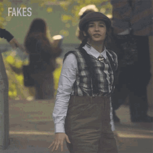 a woman wearing a plaid shirt and suspenders is standing in front of a sign that says fakes