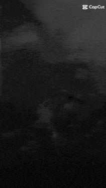 a black and white photo of a man with lightning behind him and the words capcut on the bottom
