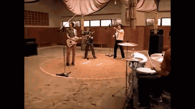 a group of people are playing instruments in a room