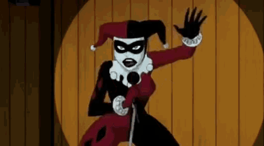 harley quinn is singing into a microphone in a wooden room .