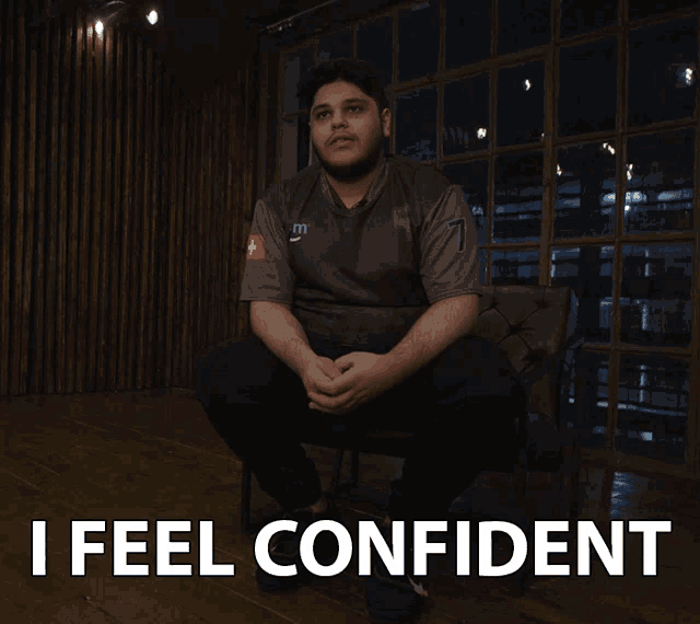 a man is sitting in a chair with the words " i feel confident " on the bottom