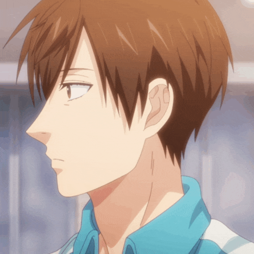 a close up of a person 's face with brown hair and a blue shirt
