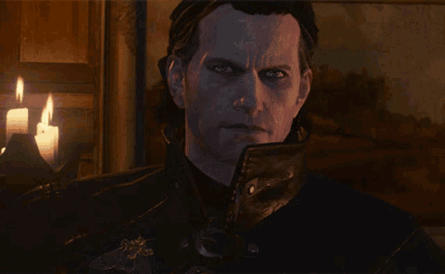 a close up of a man 's face with a candle in the background