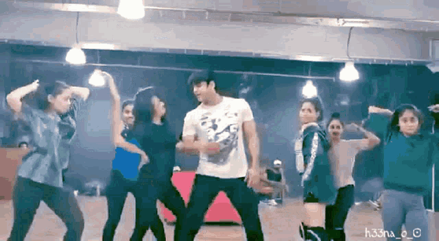 a group of people are dancing in a room with the hashtag h33na_o on the bottom