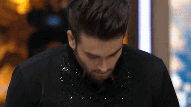 a close up of a man 's face with a black shirt on