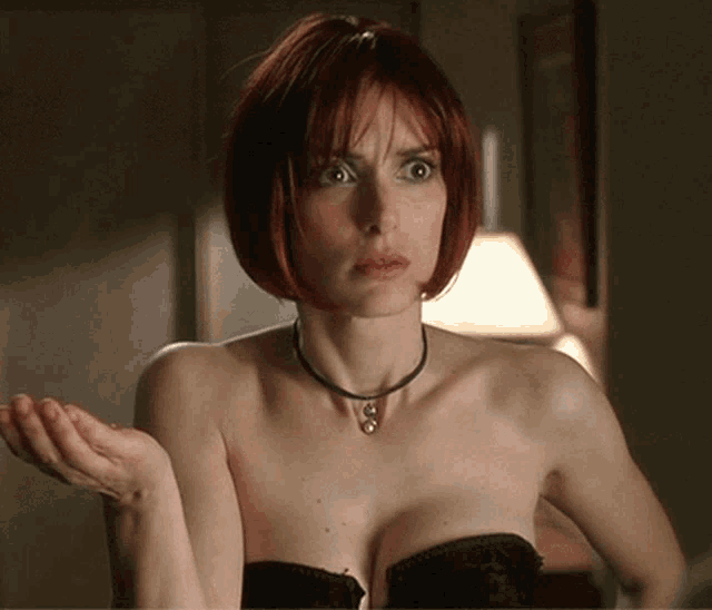 a woman with red hair is wearing a black bra and a choker