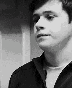 a black and white photo of a young man in a black jacket .