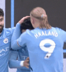 a soccer player with the number 9 on his back is hugging another player