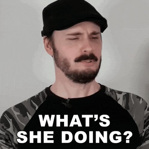 a man with a beard is wearing a black hat and a shirt that says what 's she doing