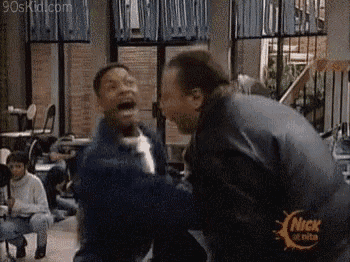 two men are laughing in a room with a nick logo on the bottom