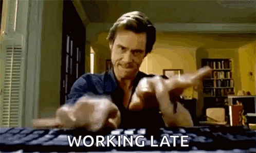 a man is typing on a keyboard with the words `` working late '' written below him .