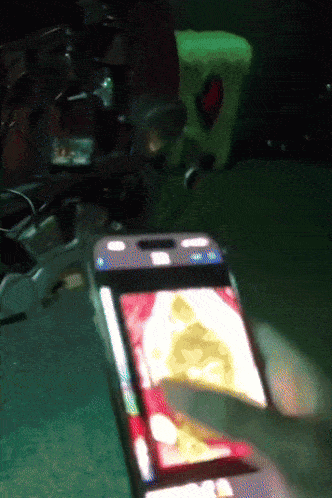 a person is holding a cell phone with a picture of a christmas tree on the screen