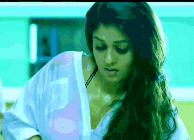 a pixelated image of a woman in a white shirt and bra