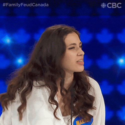 a woman wearing a white shirt with a name tag that says marjorie