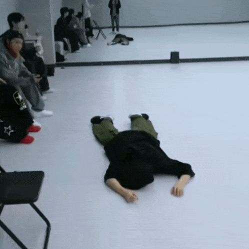 a person laying on their back in front of a mirror with the word army on their back