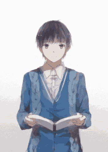 a boy in a blue jacket is holding a book in his hands
