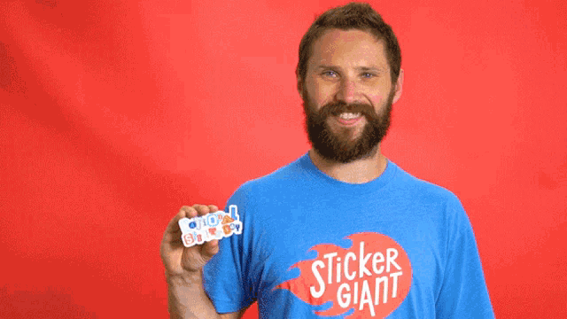a man wearing a blue shirt that says sticker giant on it