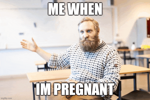 a man with a beard and mustache is sitting in a classroom with a meme that says me when im pregnant